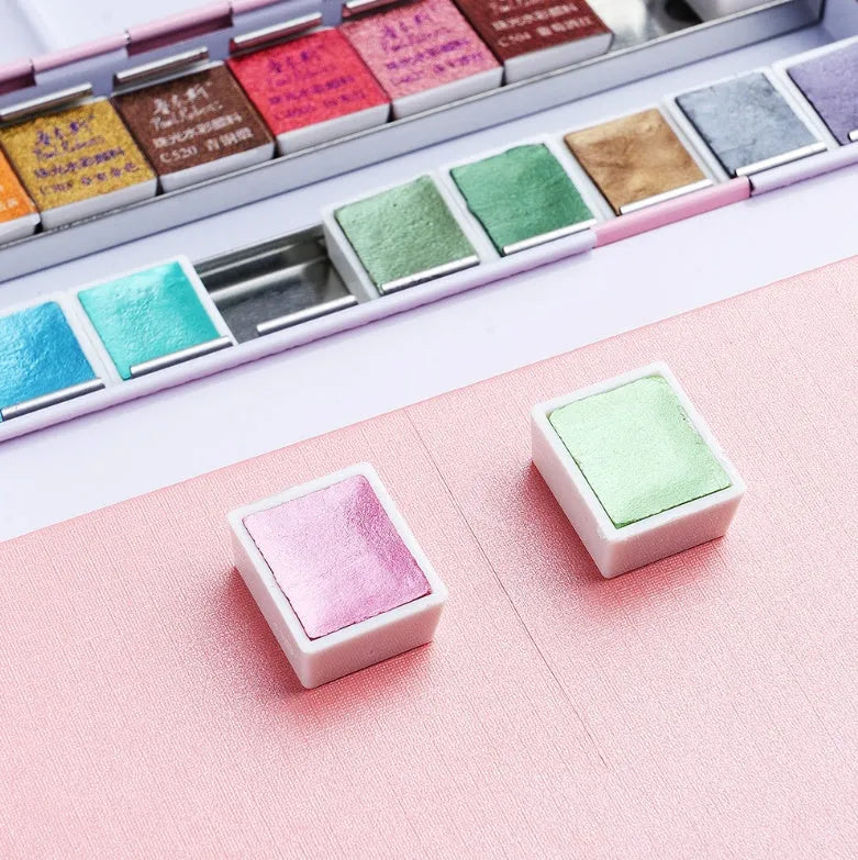 Solid watercolour paint set with pearl finish showing 12 or 24 colour pans.