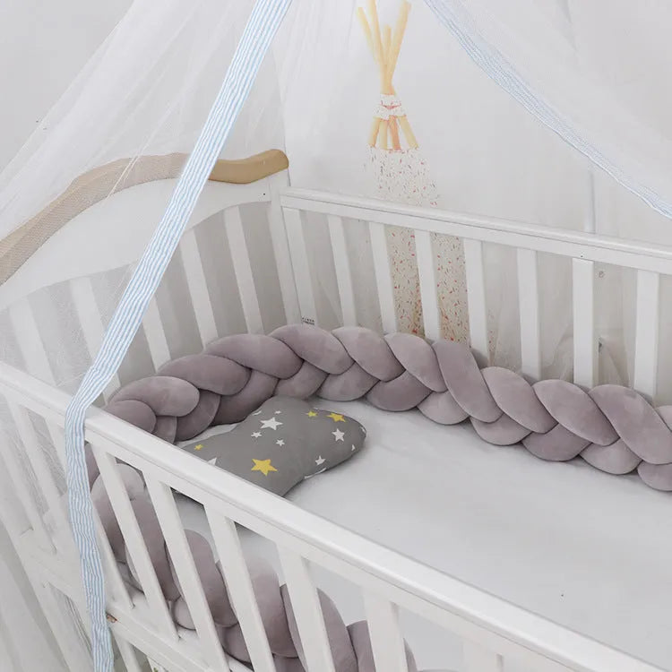 Braided knot design baby crib safety bumper in spandex velvet, shown in a light grey colour.
