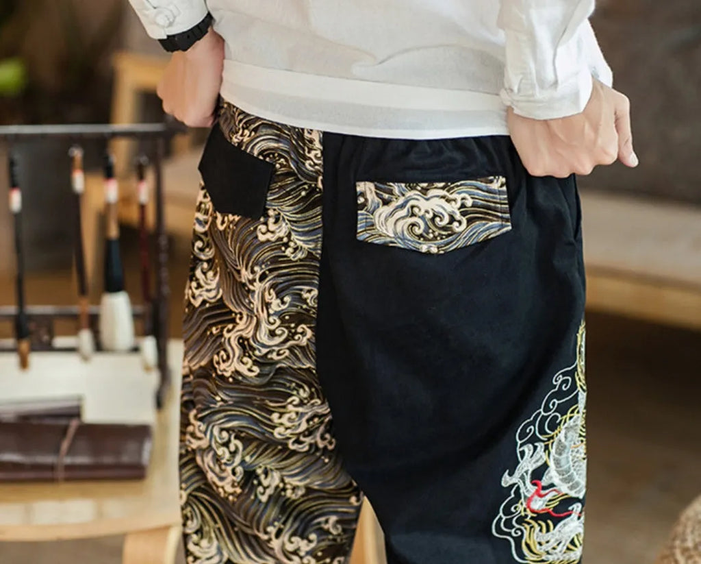 Embroidered silver dragon pattern on beige cotton casual trousers with mid-waist design