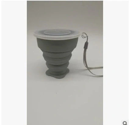 Collapsible stainless steel travel water cup showing expanded and compressed states