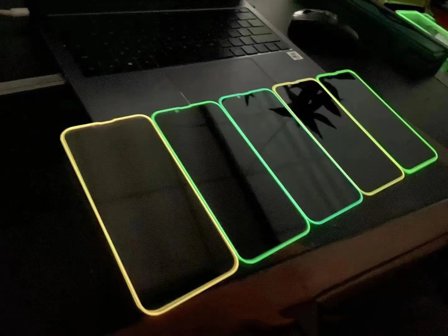 Fluorescent luminous tempered glass screen protector for iPhone in pink, yellow, green, blue, and grass green colours.