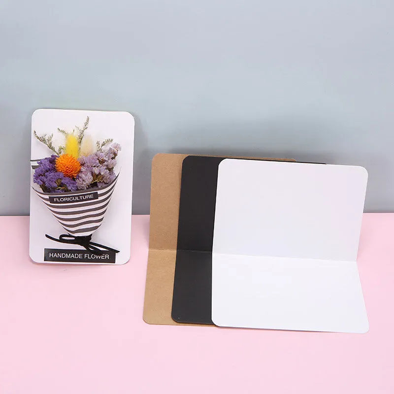 A pack of 100 folded kraft paper greeting cards in 10x15cm size, showing colour options: black, cowhide brown, and white.