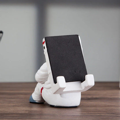 Astronaut-themed resin phone stand with unique design for desk decoration