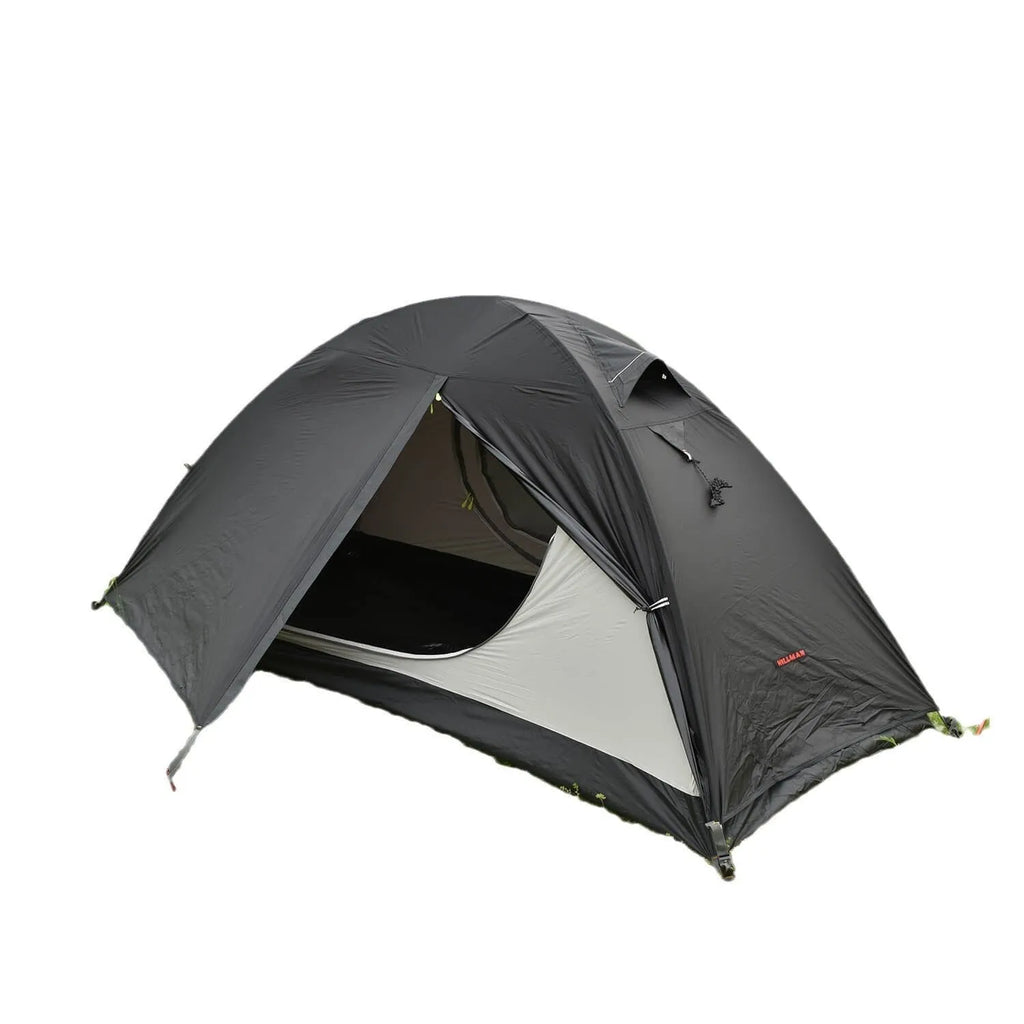 Lightweight red single person tent with aluminium poles pitched outdoors.