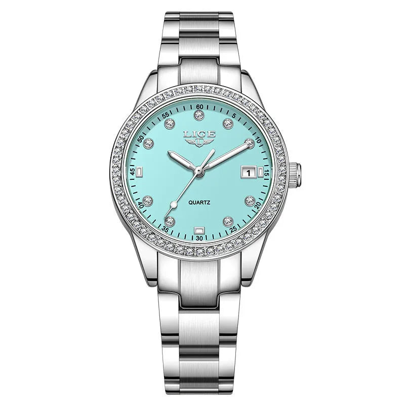 Women's silver and green quartz watch with diamond bezel, luminous hands, on a wrist.