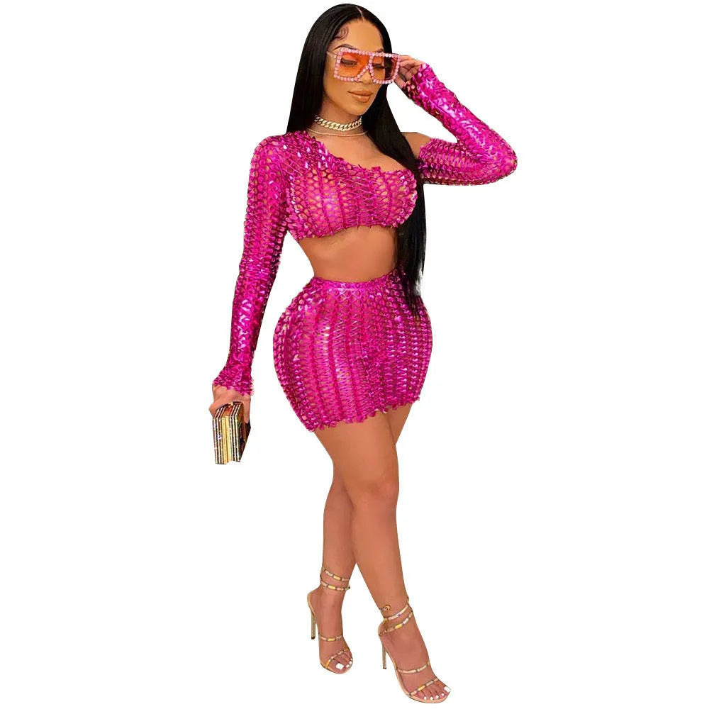 Women's black hollow-out net top and matching short skirt two-piece set on a model.