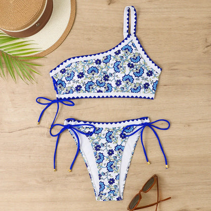 Women's blue floral one-shoulder bikini set with briefs-style bottom on mannequin