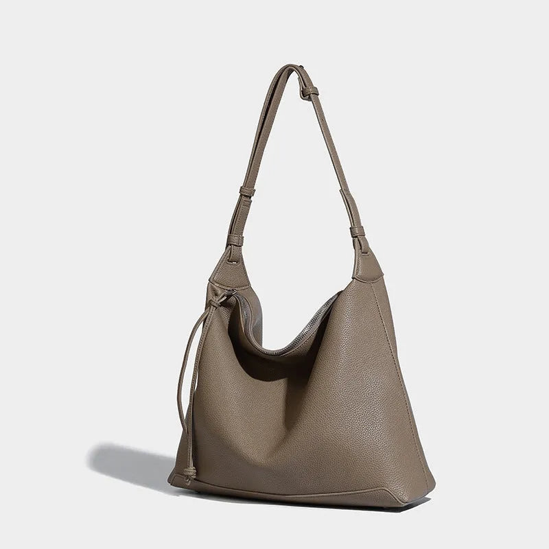 Large soft PU messenger bag in caramel colour showing shoulder strap and dimensions