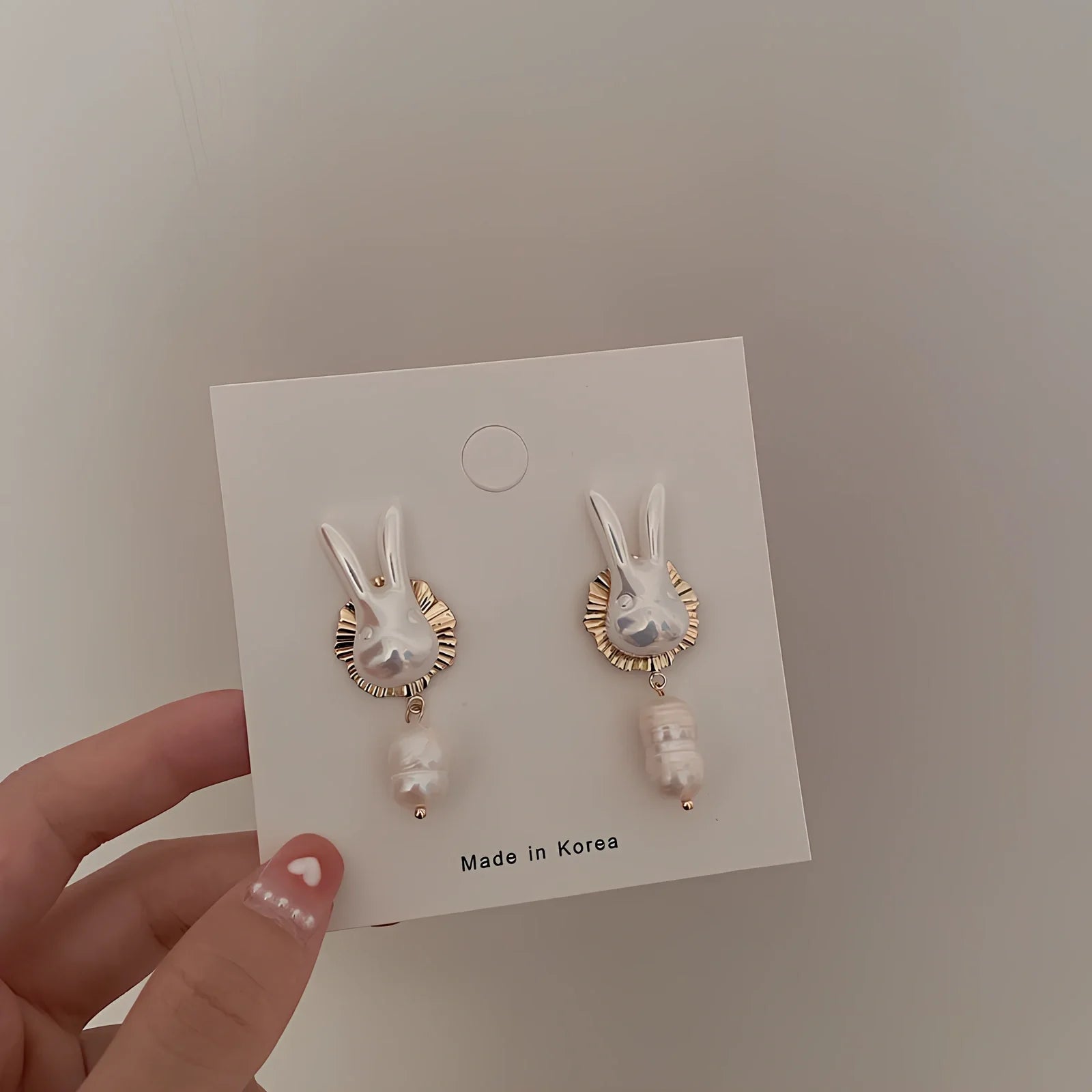 Silver bunny character earrings with baroque pearls measuring 2.5cm length with electroplated finish