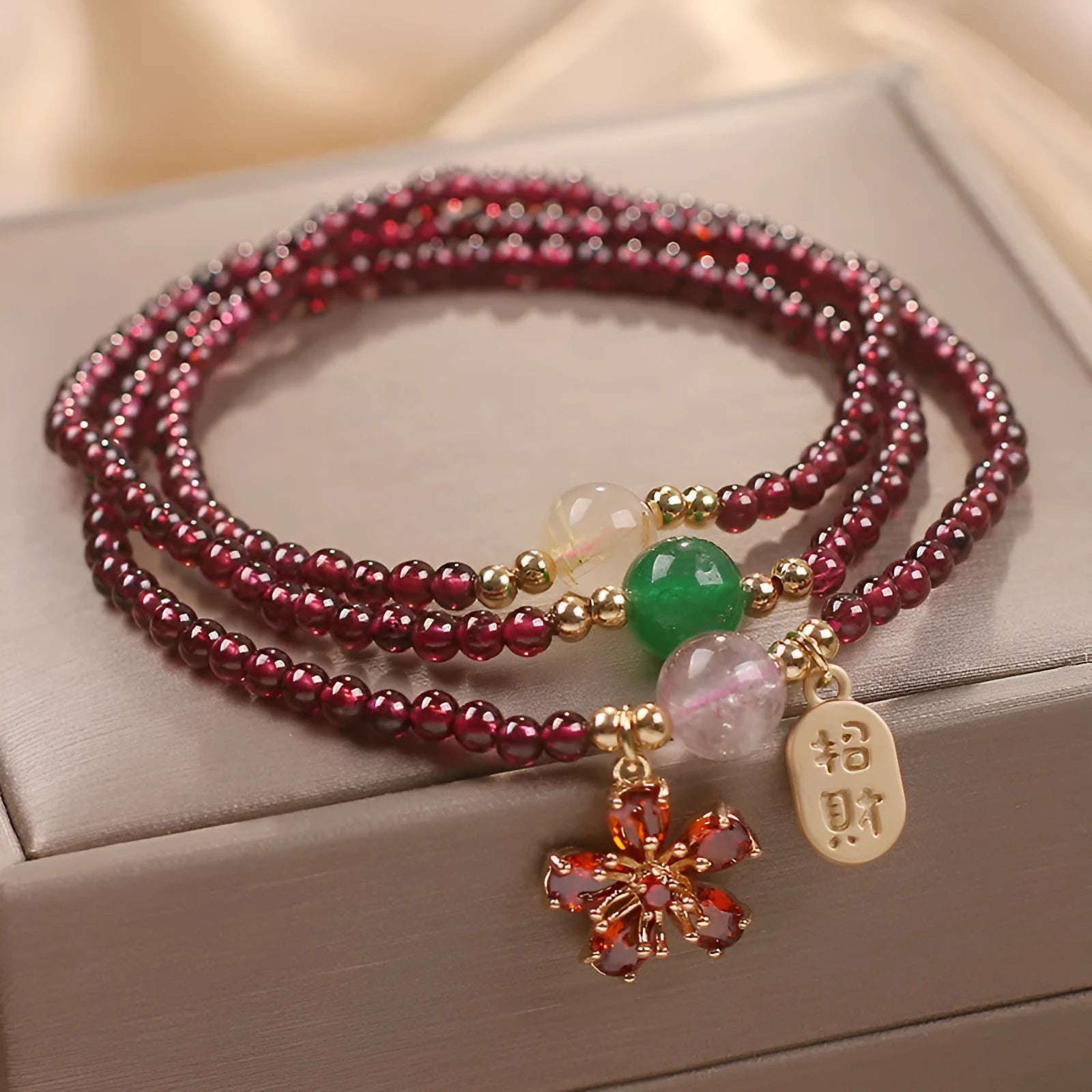 Natural crystal bracelet for women in pomegranate red cherry blossom colour with sequin detailing.