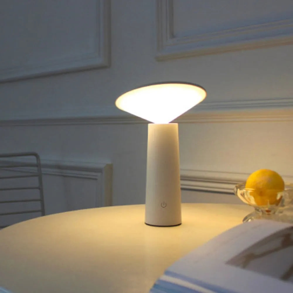 Black USB LED table lamp with touch controls and adjustable lamp head on wooden desk
