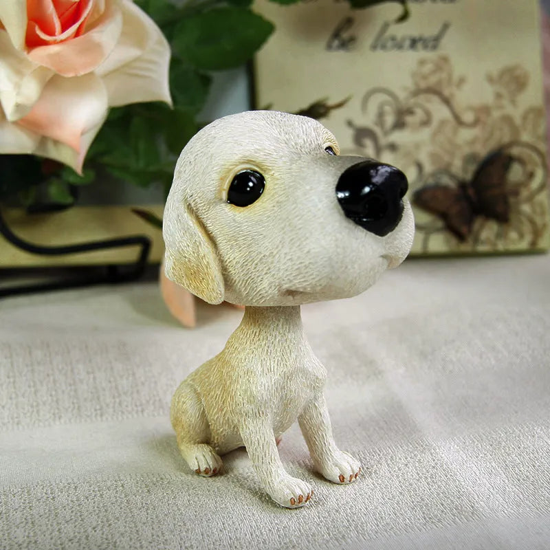 Resin moving head dog ornament in Pug colour on car dashboard