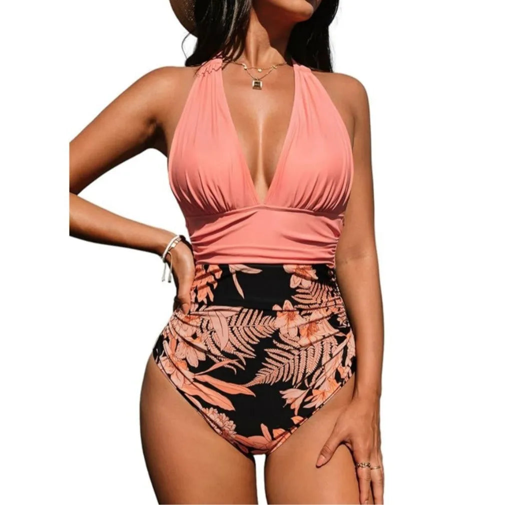 Women's pink floral halter neck one-piece swimsuit with backless design on mannequin