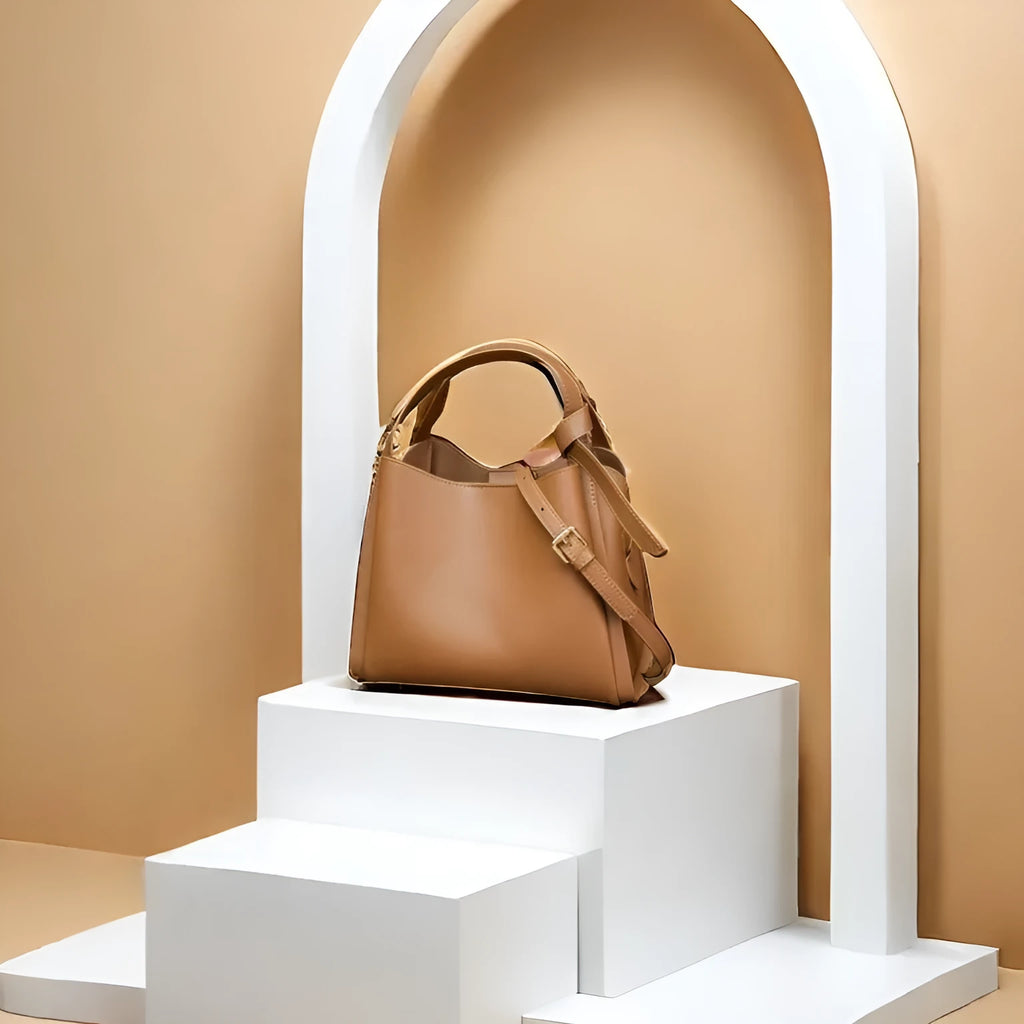 Women's soft cowhide crossbody bucket bag showing interior zipper compartments and sewing thread detailing
