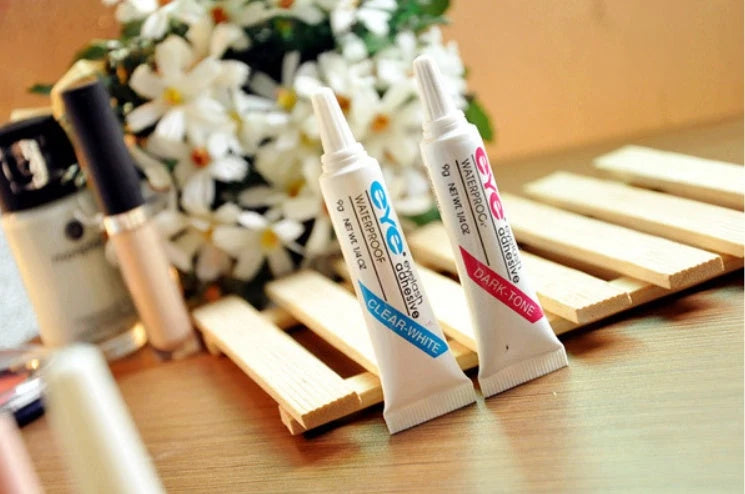 Professional false eyelash glue in black and white for natural, long-lasting eye makeup