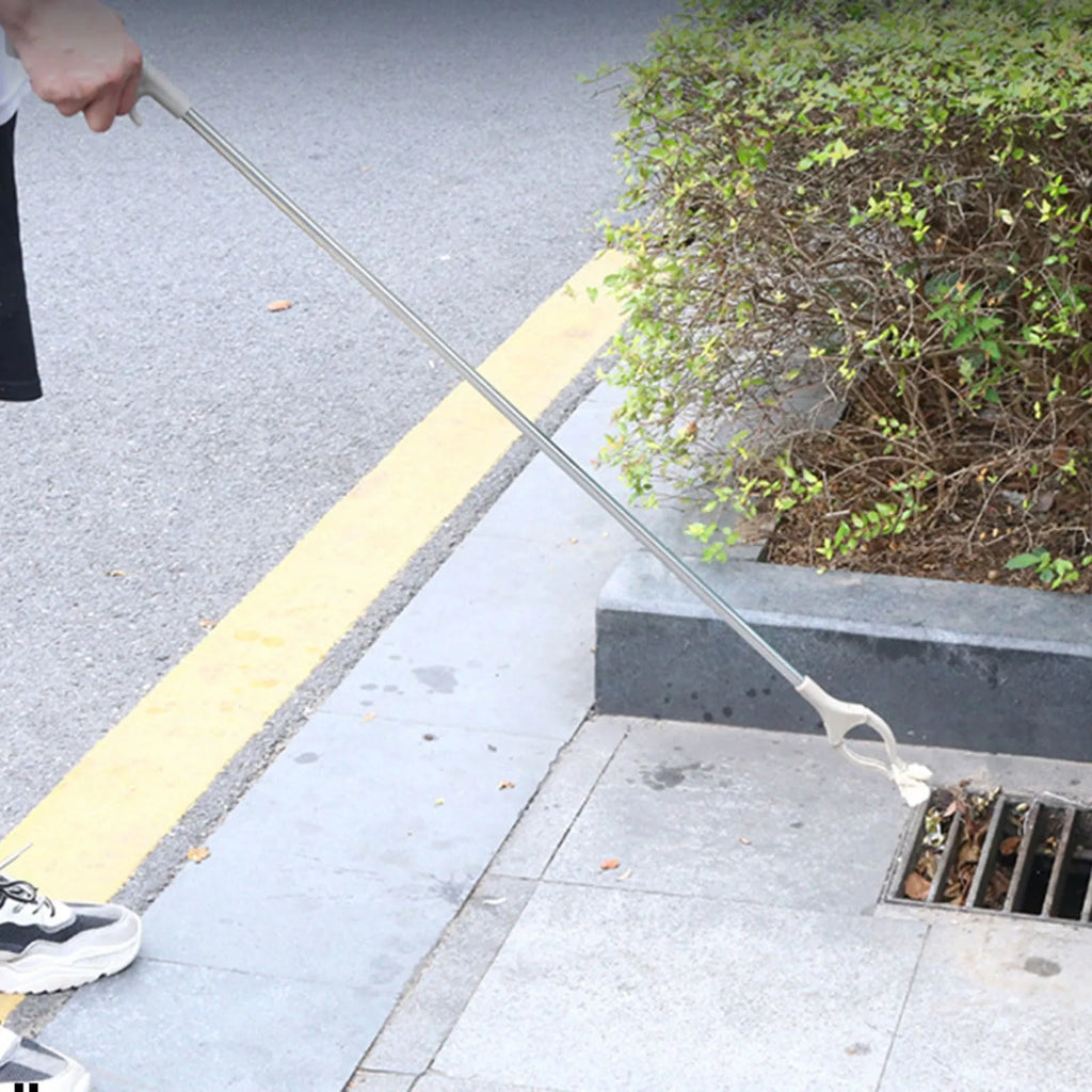Stainless steel garbage picker with extended 40cm handle and non-slip gripper jaws.