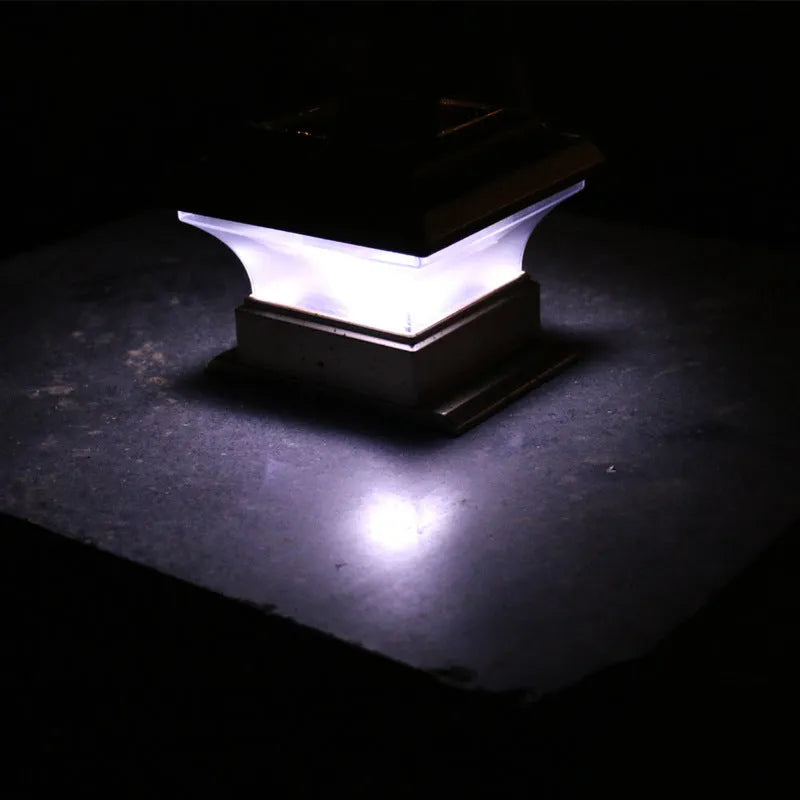 Outdoor solar column headlight with LED warm yellow light on a garden post