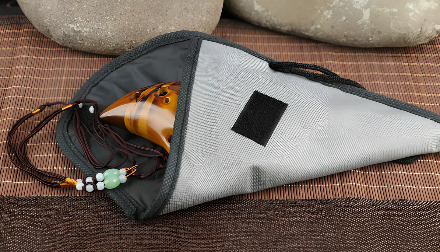 Yellow 12-hole ceramic ocarina in Alto C with 13-note range and integrated lanyard