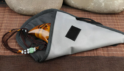 Yellow 12-hole ceramic ocarina in Alto C with 13-note range and integrated lanyard