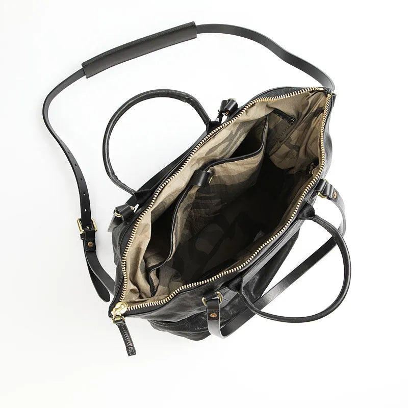Black handmade vegetable tanned cowhide tote bag with zipper closure and 15-inch computer slot for daily outdoor use