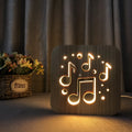 Square pine wood USB LED lamp emitting warm white light on a desk.