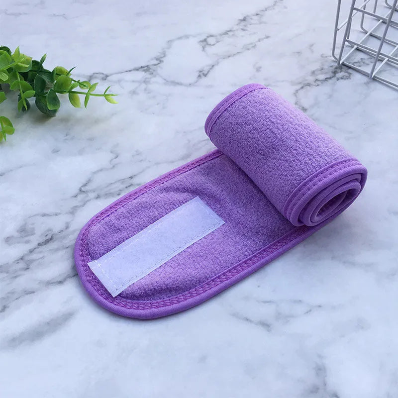 Thickened ant fabric beauty headband in white, pink, blue, purple, yellow on soft surface