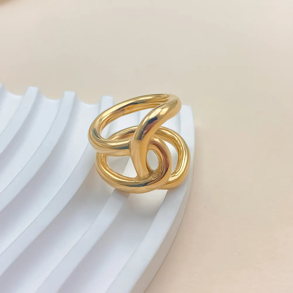 A stainless steel adjustable ring with a knotted detail on a U-shaped geometric band.