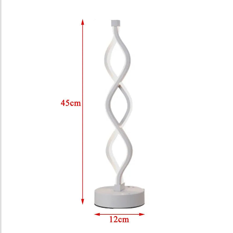 Gold LED desk lamp with acrylic shade and aluminium body on a desk