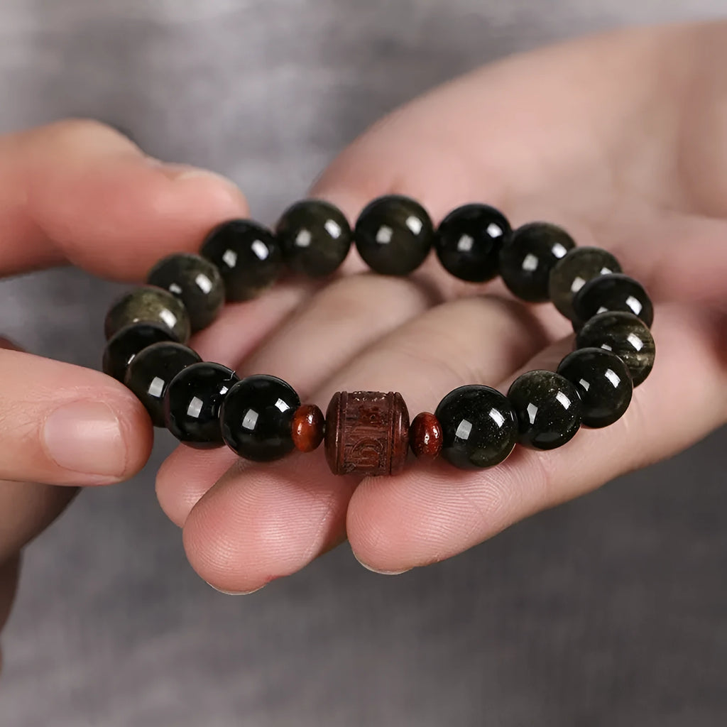 Hand-woven unisex bracelet with round 10mm golden obsidian beads in a vintage style.