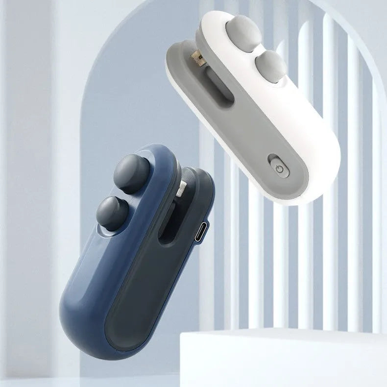 White handheld vacuum sealing machine with magnetic back and cutter blade for chip bags