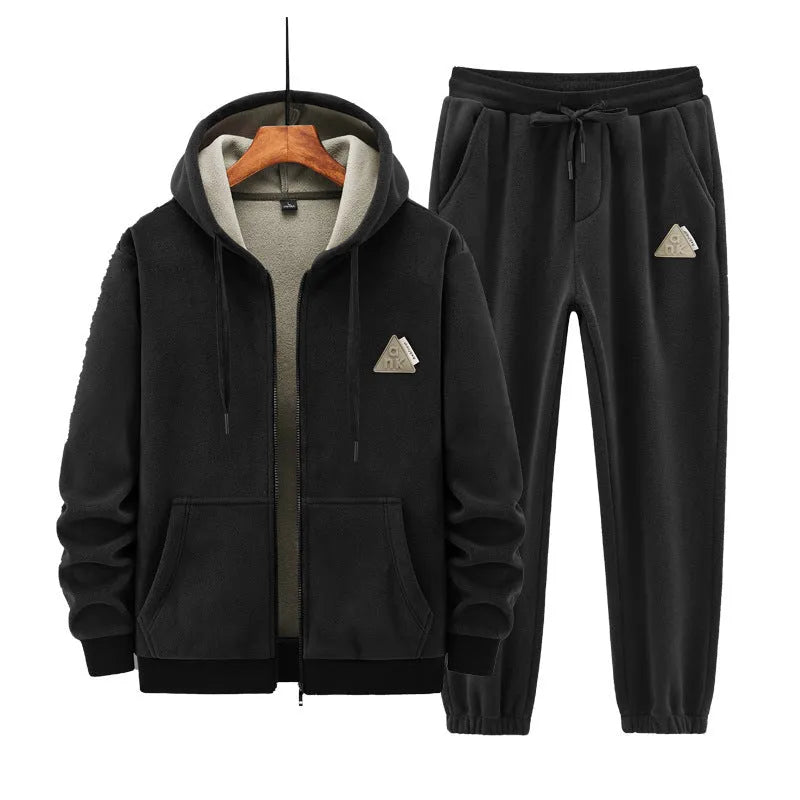 Man wearing a grey hooded cashmere sweater and matching cotton trousers from a casual sports suit set.