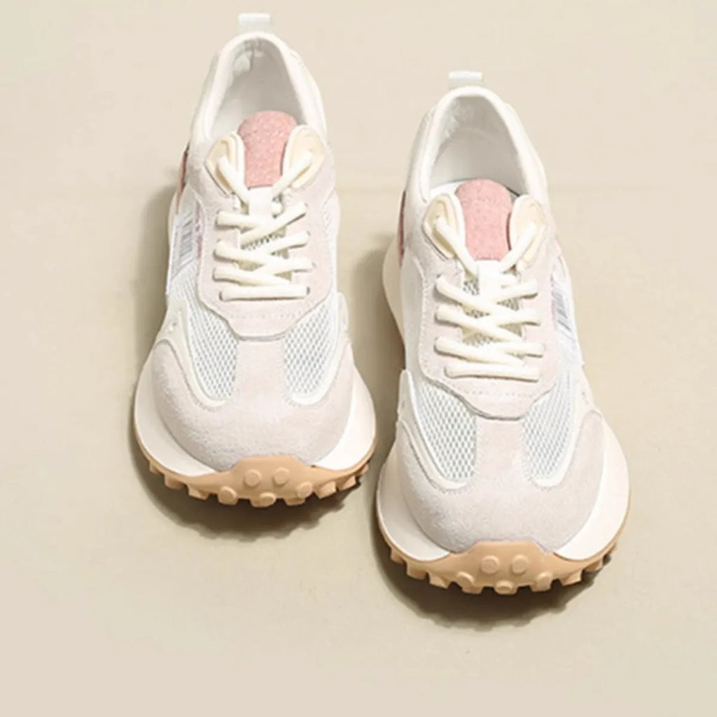 Women's low-top retro sneaker in grey or pink with round toe and rubber sole.