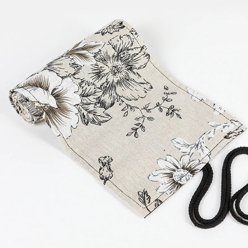 Black peony floral print pencil roll bag open to show multiple pencil slots.