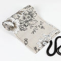 Black peony floral print pencil roll bag open to show multiple pencil slots.