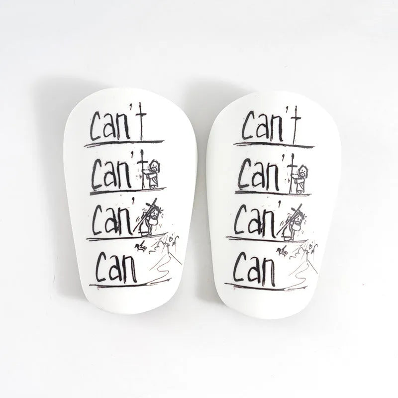 A pair of white PU football shin guards for adult training, showing the strap and protective shell.