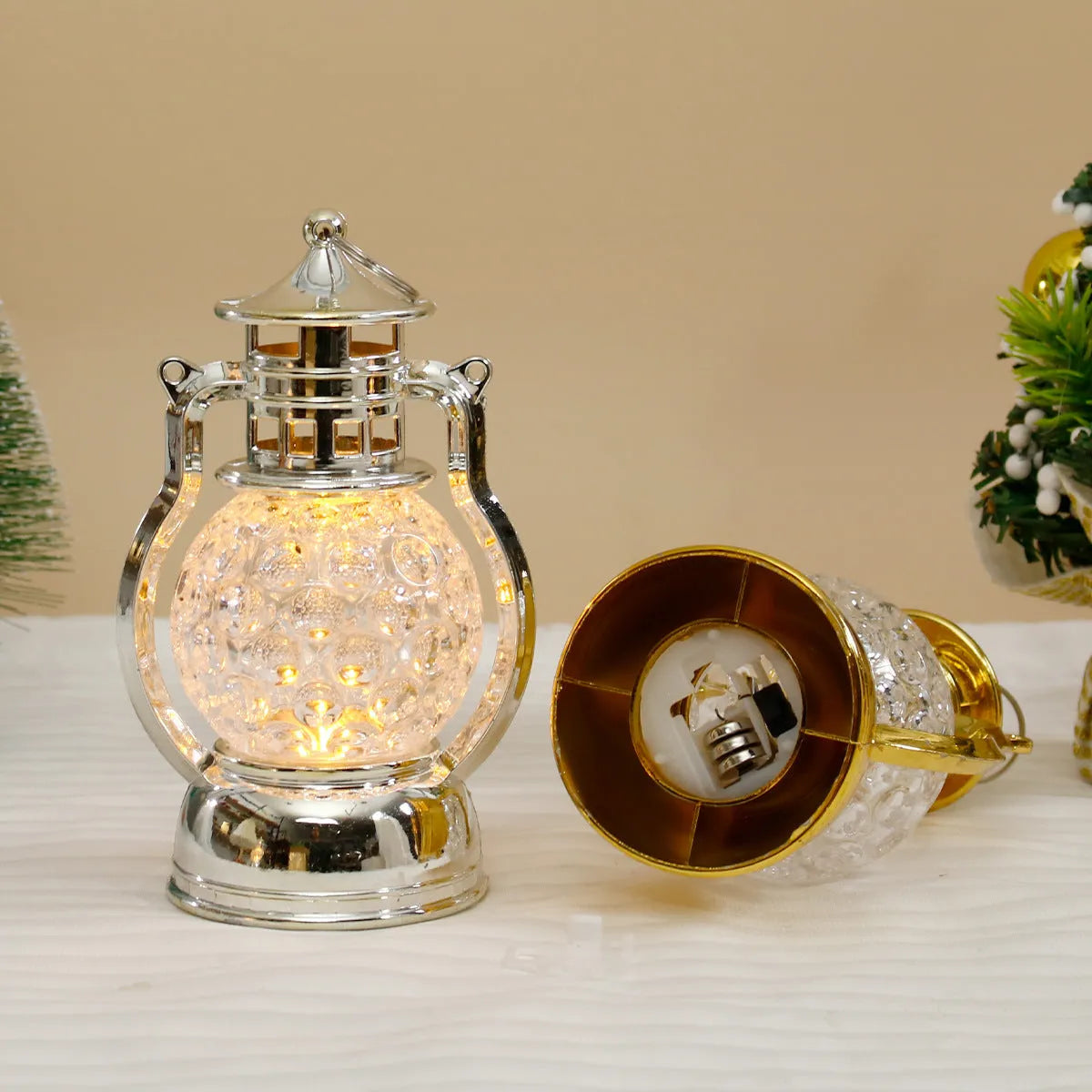 Creative retro-style oil lamp LED night light in gold or silver finish on a dark surface