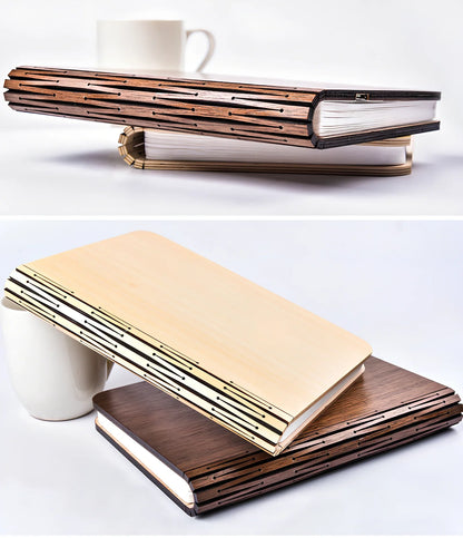 Wooden folding LED book light in walnut finish, open to 360 degrees showing warm white illumination on Tyvek pages, 21.5cm size