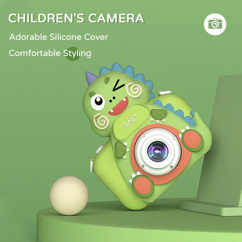 Children's mini cartoon camera with silicone body, Big Head Dinosaur colour, with lanyard and charging cable on white background