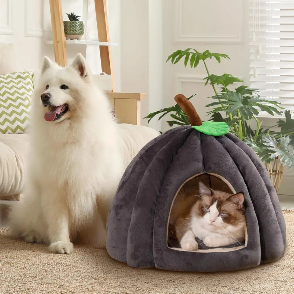 A grey pumpkin-shaped semi-enclosed cat bed with a plush interior, shown on a wooden floor.