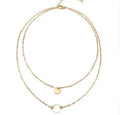 Gold multi-layer sequined choker necklace with drop pendant on woman's neck