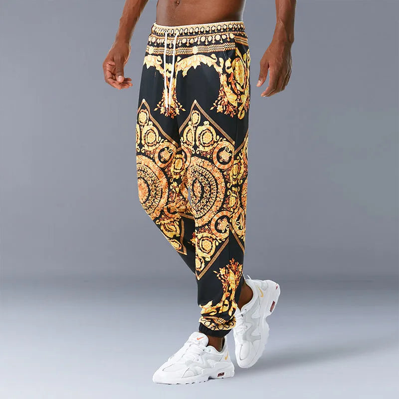Printed jogging pants in loose fit with digital print pattern, mid waist, drawstring belt, and small-foot ribbed hem