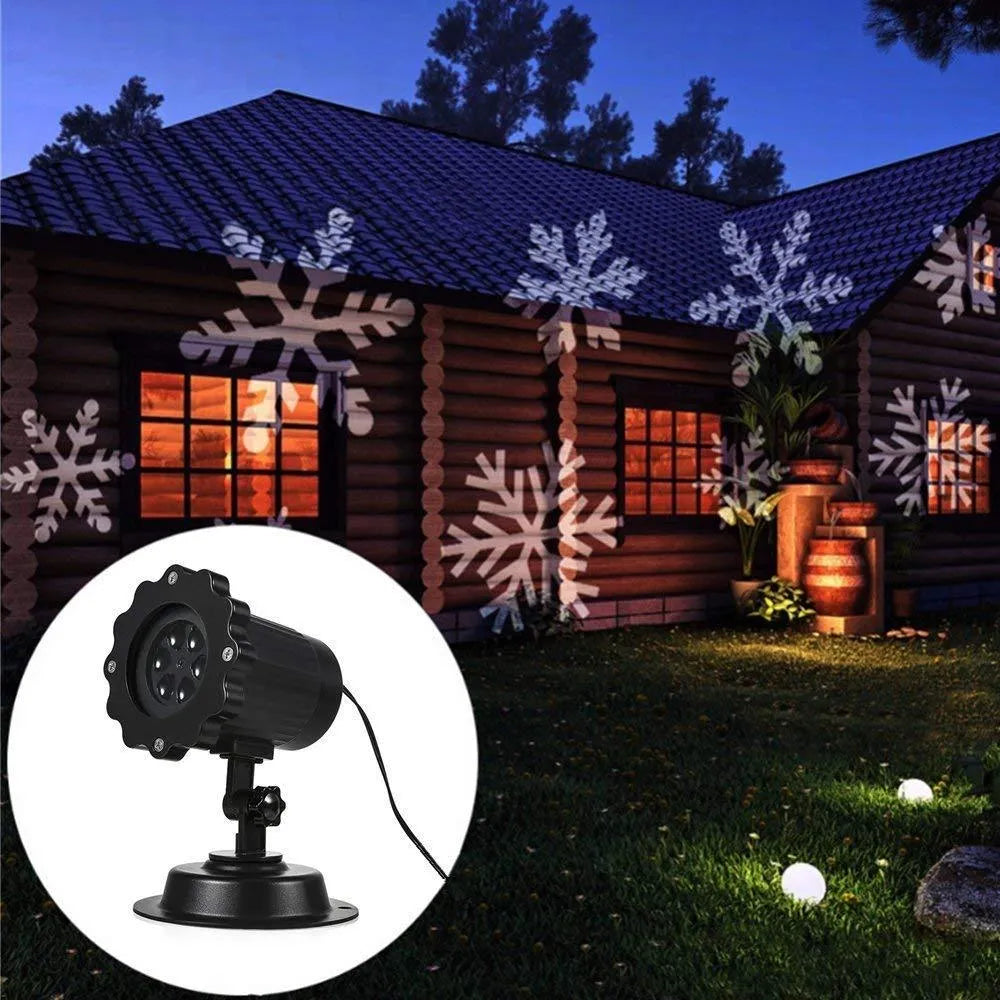 LED Christmas snowflake laser projector with white snowfall pattern on a garden lawn at night