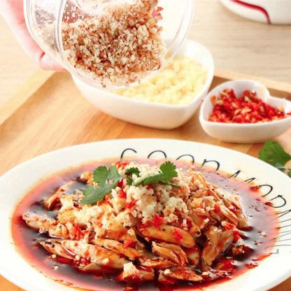 Manual cutting meat grinder with stainless steel blades on a kitchen counter