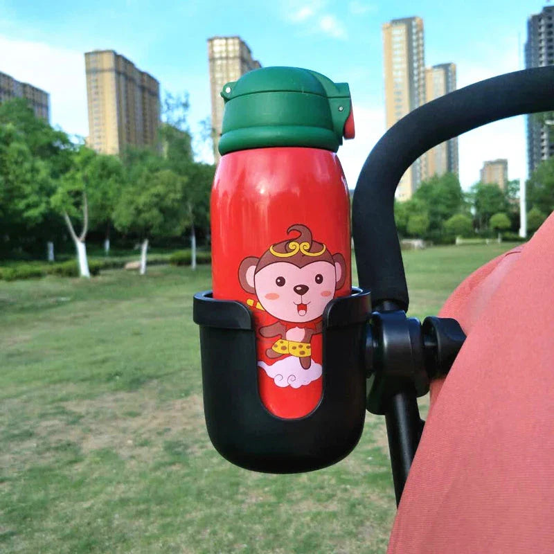 Universal baby stroller cup holder with phone pocket attached to a stroller