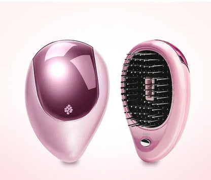 Portable negative ion hair comb with sound wave vibration technology in pink and green