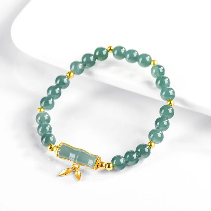 Blue water natural jade beads on a sterling silver high-rise bracelet for women.