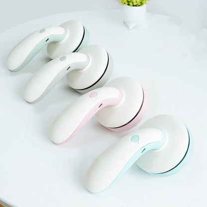 Mini desktop vacuum cleaner in pink, green, blue, and grey for dust removal