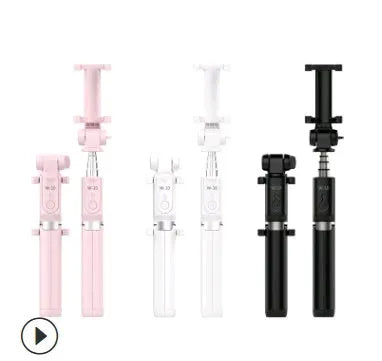 Aluminium telescopic Bluetooth selfie stick with tripod base and remote control next to a smartphone.