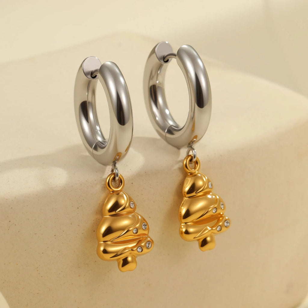 A pair of stainless steel earrings with 18K gold plating in a Christmas tree and heart shape design.