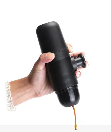 Black portable manual espresso maker showing compact 17.5cm height and 6cm diameter.